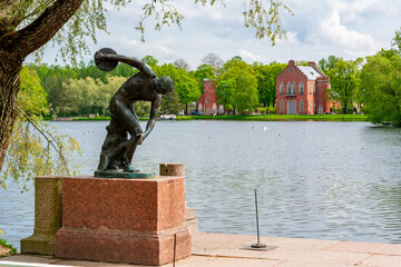 Sculpture of discus thrower at Grand pond with Admiralty buildings at background, Tsarskoe Selo...