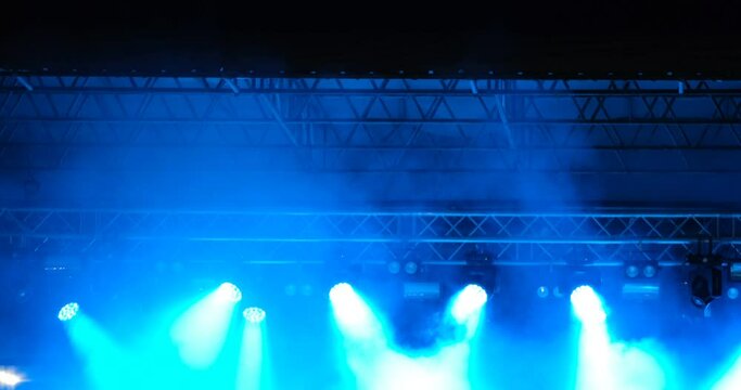 Light from the stage. Silhouettes of hands in concert.