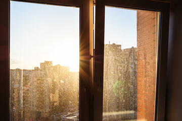 sun rays illuminate home dirty window