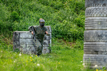 young woman in action while playing paintball