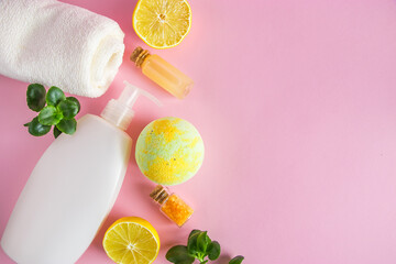 Natural cosmetics for skin care with lemon. Organic beauty product with citrus on a pink background.
