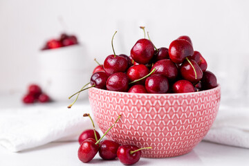 Fresh beautiful cherries in a pink bowl