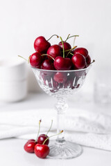 Fresh beautiful cherries in a cut crystal glass