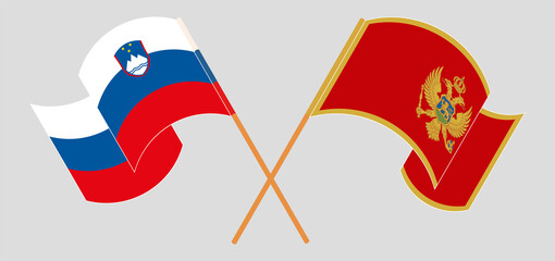 Crossed and waving flags of Slovenia and Montenegro
