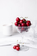 Fresh beautiful cherries in a cut crystal glass