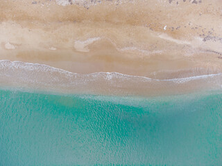 Top down view of waves in a Greek beach