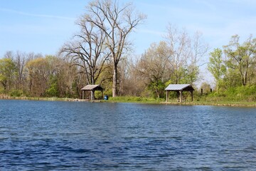 The wood shelters at the lake in the country.