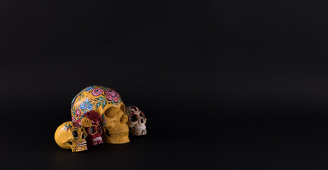 Day of the Dead, colorful skulls on black background