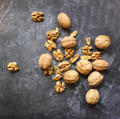 Walnut in wooden bowl on black background with copy space.Top view. Wooden plate with walnut on black background. Space for text