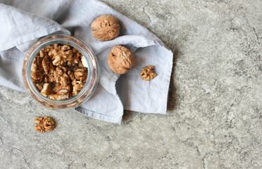 Walnut on grey background with copy space.Top view. Wooden plate with walnut on black background. Space for text