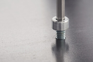 Hex wrench screw hex bolt in metal steel plate. Spanner, bolt, screw and nuts.