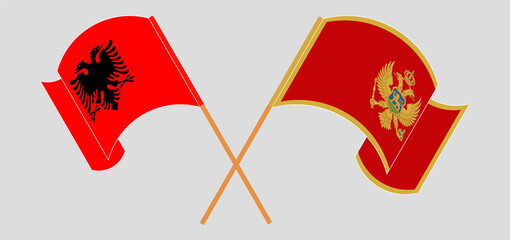Crossed and waving flags of Albania and Montenegro