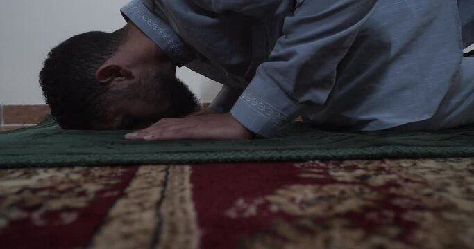 religious muslim praying on his carpet