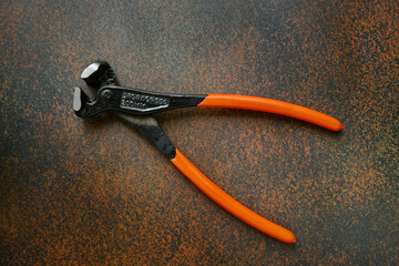 Locksmith pliers, drop forged metal, professional realistic tool on a dark background close up