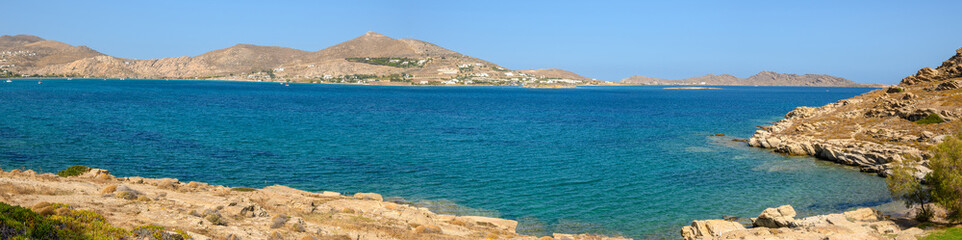 Fototapeta na wymiar Beautiful bay with blue crystal waters in Naoussa village. Paros island, Greece