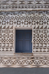 Carved geometric shapes on a wall in the Pyrgi village at South Chios Island
