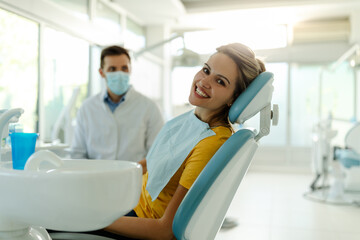 My smile is perfect! Portrait of happy patient in dental chair.