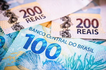 The detail of the two hundred and one hundred reais notes. The real is the currency of Brazil. 