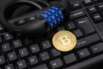 Cryptocurrency bitcoin with lock on keyboard. Bitcoin security.