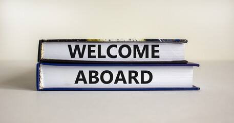 Welcome aboard symbol. Books with words 'Welcome aboard'. Beautiful white background. Business, welcome aboard concept, copy space.