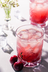 Beautiful red cherry cocktail in the summer sunshine