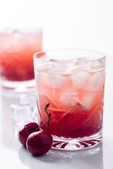 Beautiful red cherry cocktail in the summer sunshine