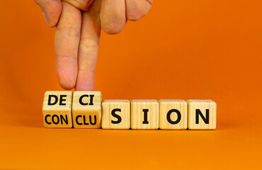 Decision or conclusion symbol. Businessman turns wooden cubes and changes the word 'conclusion' to 'decision'. Beautiful orange background. Business, decision or conclusion concept. Copy space.