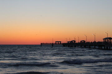Fototapeta na wymiar Fishing pier at the beach after the sunset