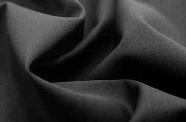 Cloth. Part of the dark fabric texture of the fabric for the background and decoration of the work of art, a beautiful crumpled pattern of silk or linen. A crumpled piece of cloth