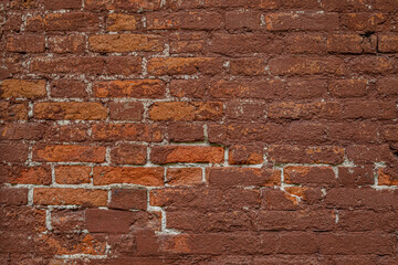 abstract background of an old painted shabby red brick wall close up