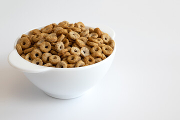 cereal cheerios in bowl on white background
