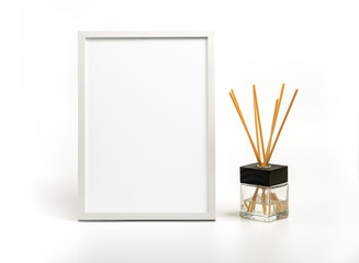 White vertical picture frame and incense decoration on white backgrtound. Clipping path for a frame
