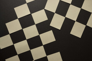 pale yellow square rectangles on dark grey board - photographed from above in a flat lay composition