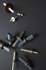 rusty metallic washers (stuffed with papers tubes)  -  and various pieces of yellow paper - photographed from above in a flat lay style