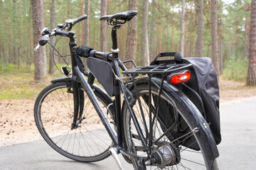 Fototapeta na wymiar bicycle parked on the forest path, bicycle path in the forest, bicycle tail light