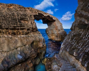 Wied il-Mielaħ; a magnificent natural limestone arch, sculpted by centuries of weathering, found in the northern border of the island of Gozo