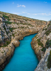 Calm and colourful sea over the valley of Wied il-Ghasri, Gozo