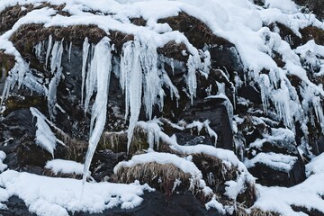 Icicles hanging from a rock wall at Tännforsen waterfall in northern Sweden - 435715933