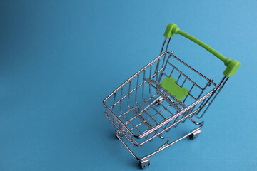 shopping cart on a blue background with a copyspace. purchases. business. Buyer demand. shop. Buyers