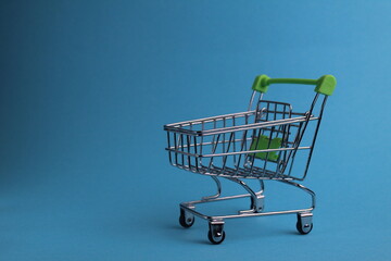 shopping cart on a blue background with a copyspace. purchases. business. Buyer demand. shop. Buyers