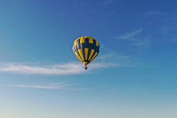 Hot air balloon in flight at sunset. View from the drone. 
