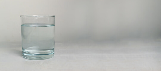 Banner glass tumbler with clear water.