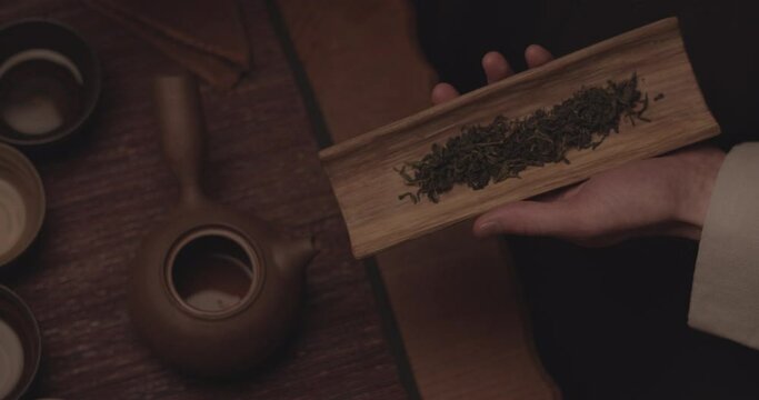 Rectangular Plate on Left Hand while He Opens Up the Pot Lid with the Right