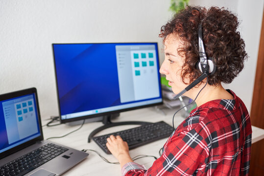 Woman telecommuting at an adjustable standing desk