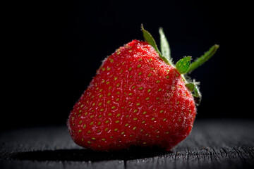 strawberry dewy water on a black tree