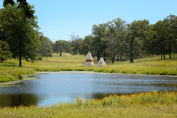 Teepee"s behind a lake in Oklahoma © Martina