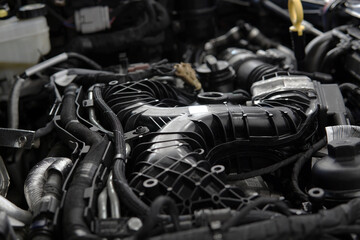 Close-up of a modern powerful engine. Top section, intake manifold, selected focus.
