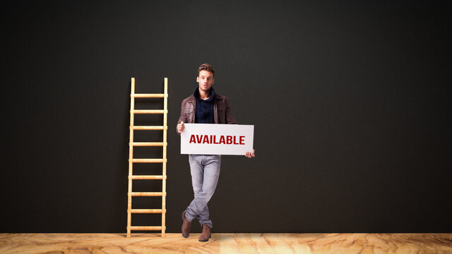 man holding a sign with the word AVAILABLE in front of a blackboard with a ladder