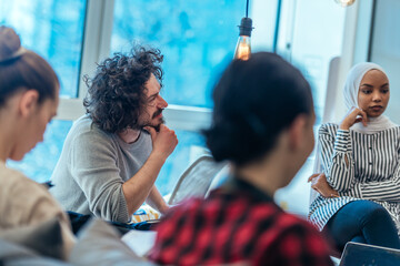 Business meeting between multi ethnic colleagues in a modern startup company.