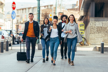 Naklejka premium Friends Bonding, group of multi-ethnic friends walking on the streets talking to each other and smiling.